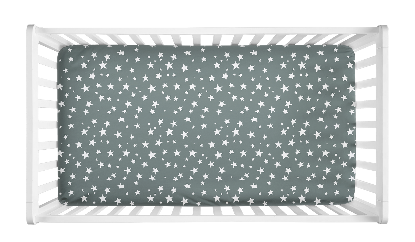 Sage green crib sheet with white star pattern in crib