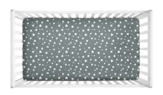 Sage green crib sheet with white star pattern in crib