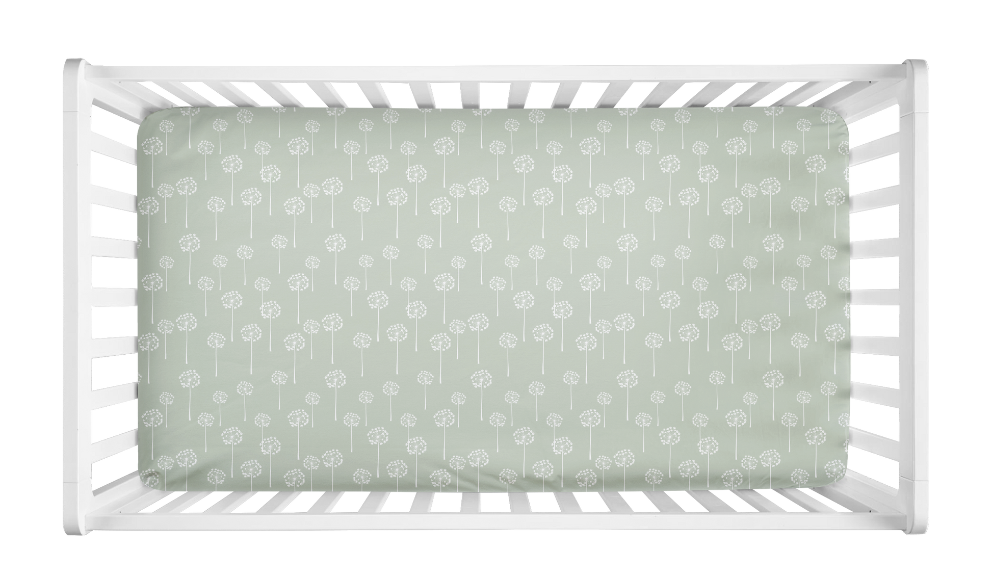 Crib sheet with sage green background and white dandelion print, styled in a white crib for a botanical or minimalist baby girl nursery