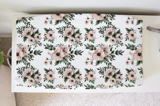 Changing pad cover with blush and sage watercolor flowers and greenery on white background