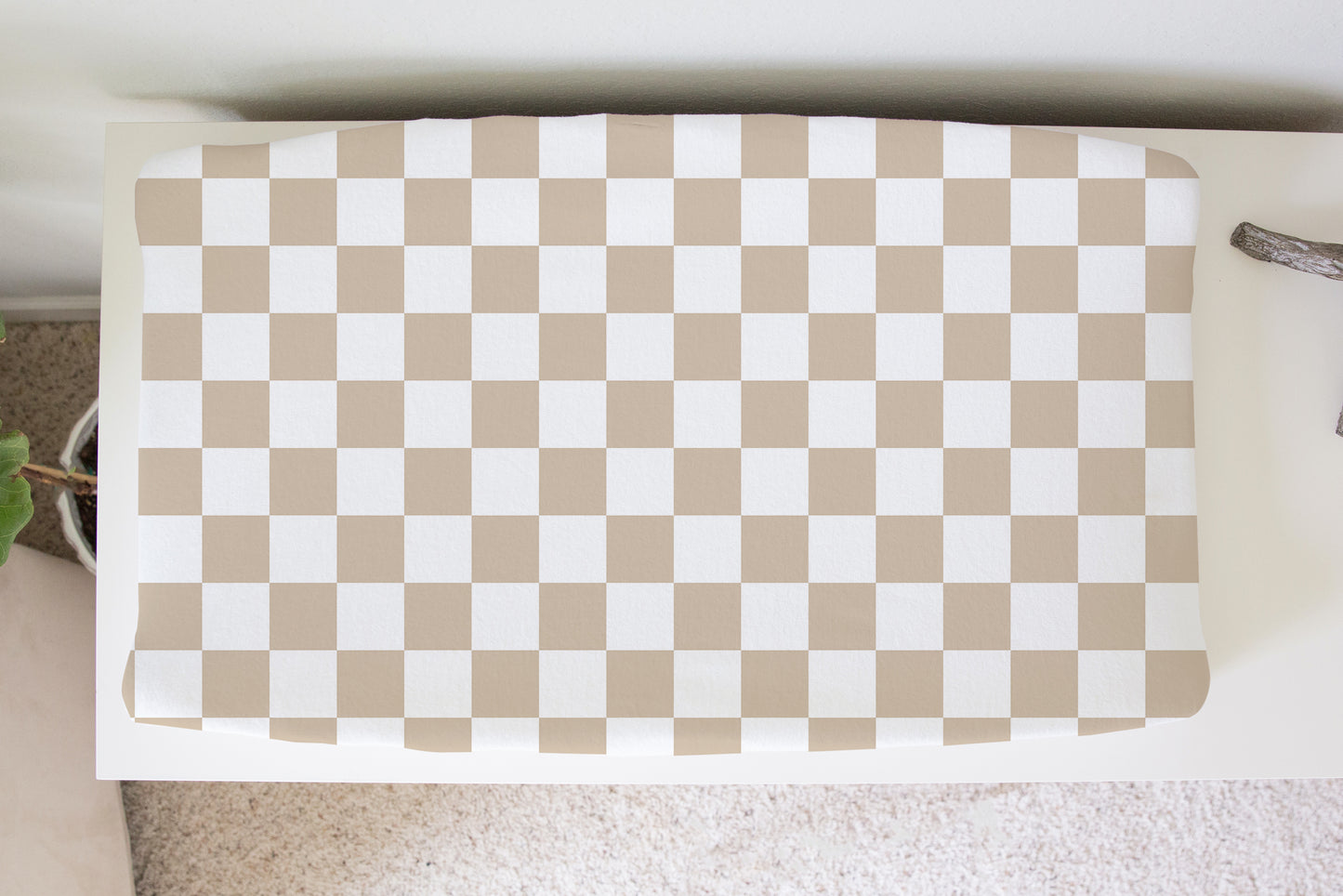 Neutral beige and white checkerboard changing pad cover for baby nursery, soft modern gender-neutral baby bedding.