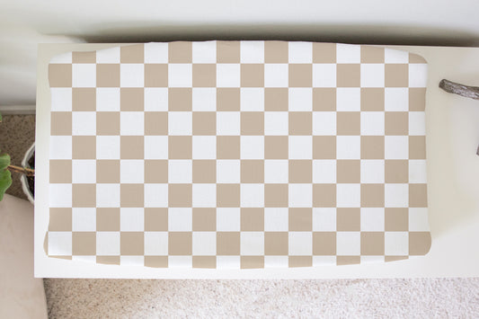 Neutral beige and white checkerboard changing pad cover for baby nursery, soft modern gender-neutral baby bedding.