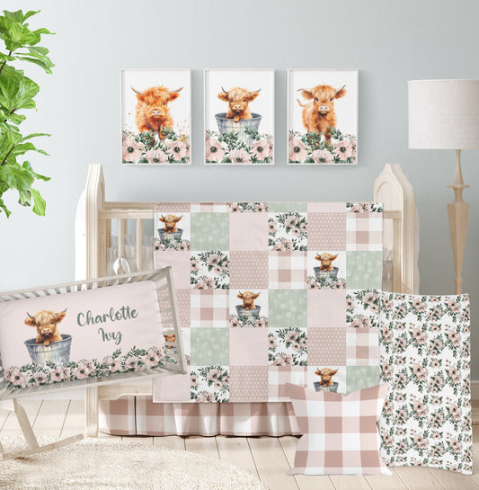 Highland cow crib bedding with floral blush and sage patchwork design, styled in a rustic nursery with coordinating cow wall art
