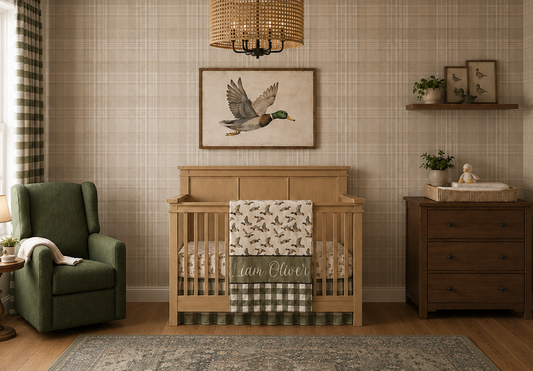 Classic baby boy duck nursery mood board with personalized mallard crib bedding, sage plaid accents, natural wood crib, green glider, vintage rug, plaid wallpaper, duck wall art, blackout curtains, and woven light fixture.