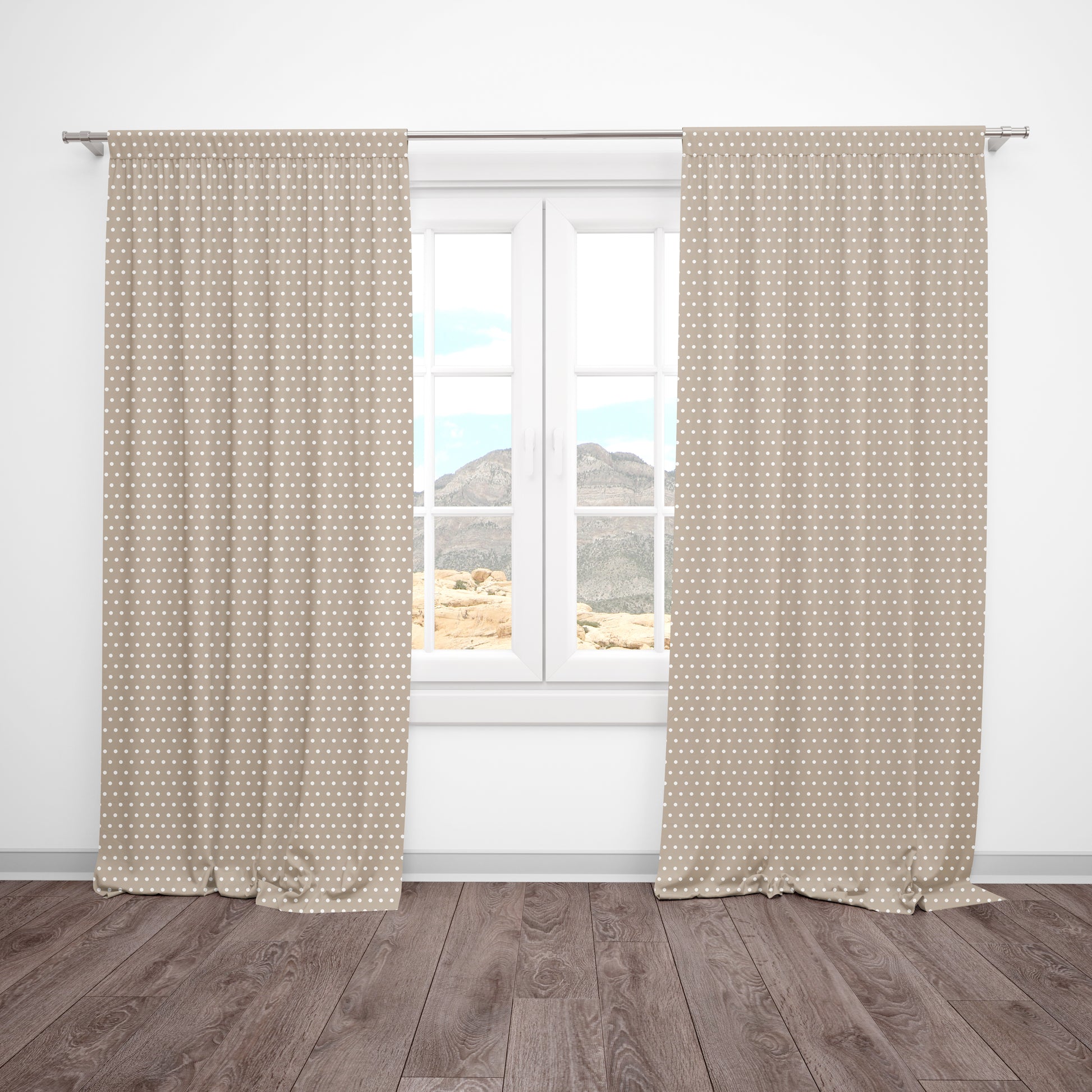 Beige and white polka dot curtains hanging in a neutral baby nursery or kids' room.
