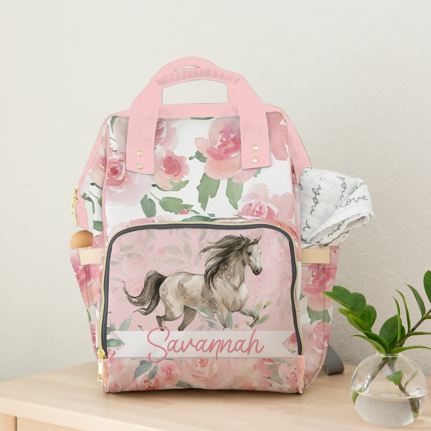 Baby Girl Diaper Bag with a pink floral design and trotting horse