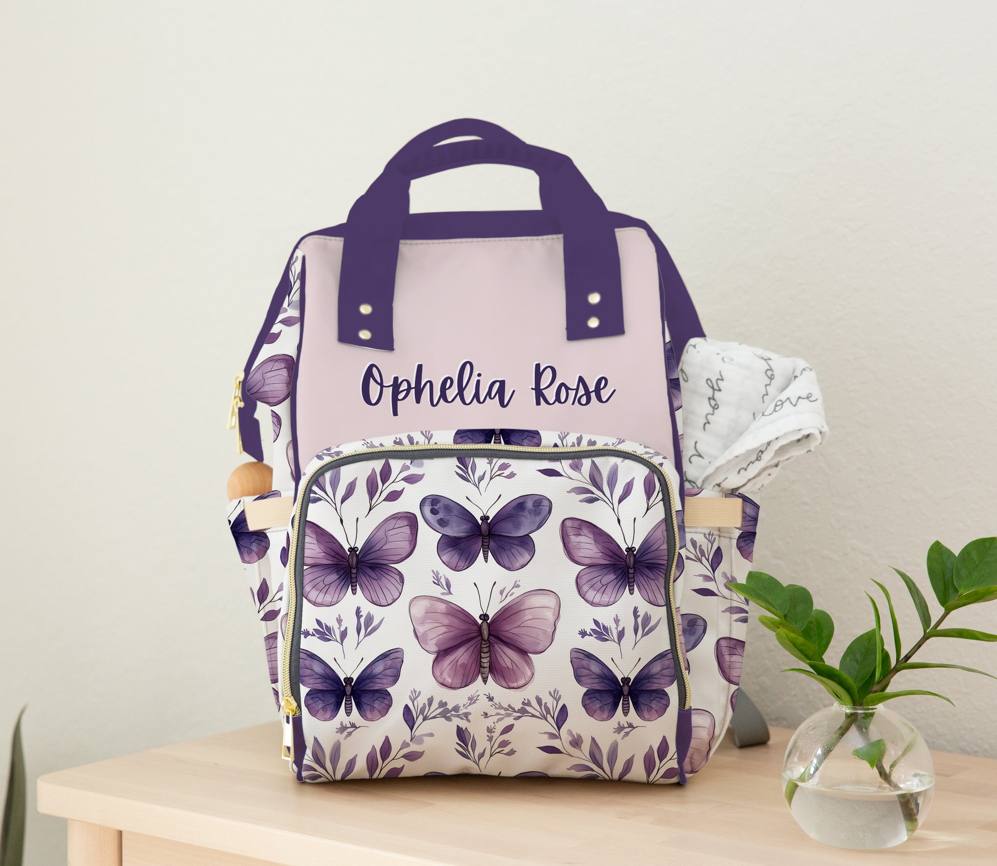 Personalized purple butterfly diaper bag backpack with lavender watercolor butterfly print and custom baby girl name design.
