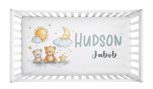 Personalized celestial crib sheet with teddy bears, stars, and custom baby name in crib