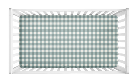 Sage green gingham baby crib sheet inside white crib