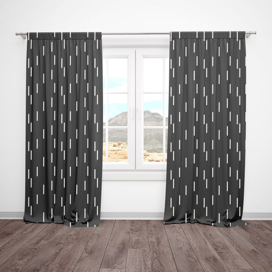 Black blackout curtains with white dash pattern in modern nursery setting